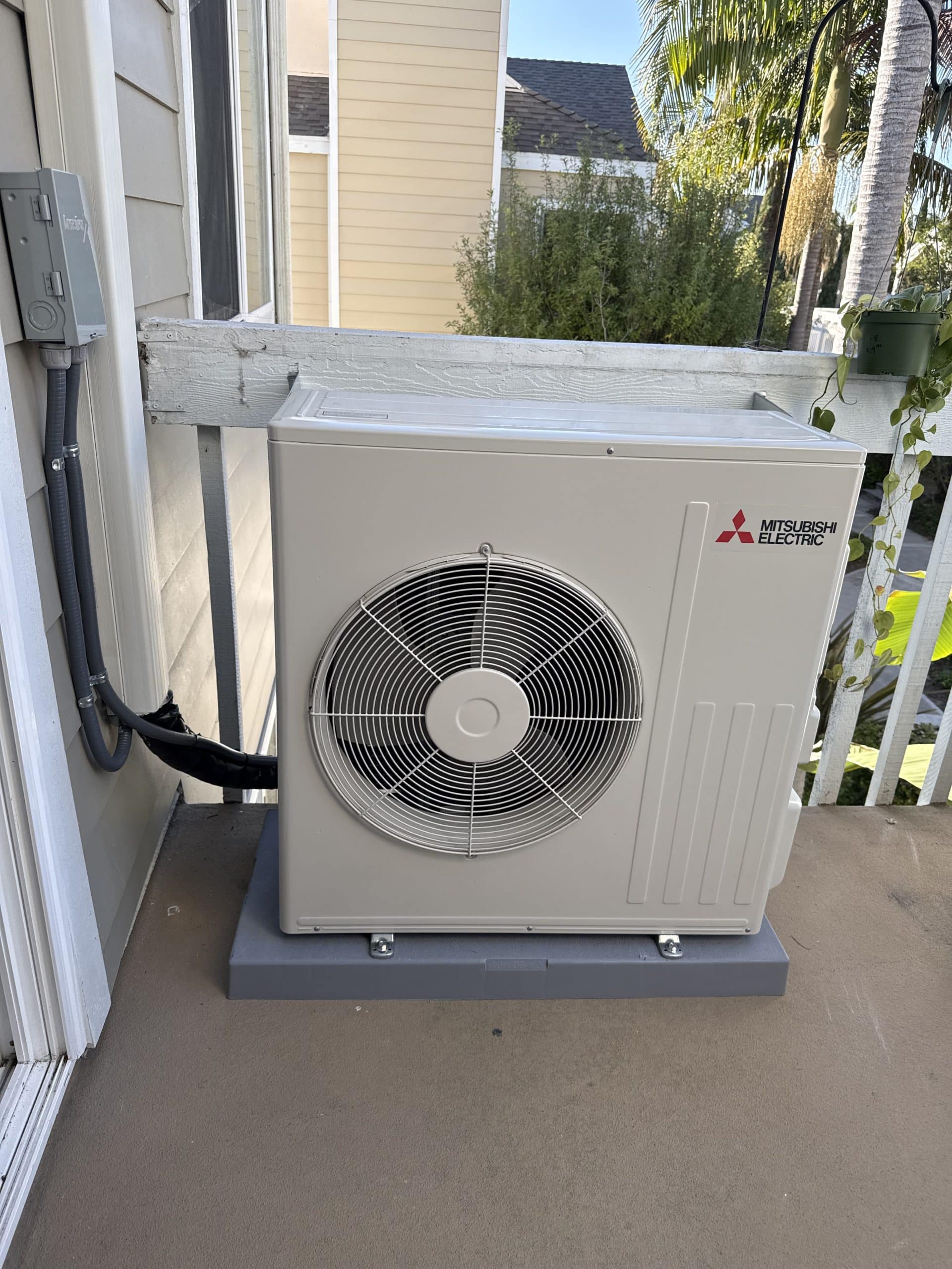 Outdoor Mitsubishi air conditioning unit on balcony
